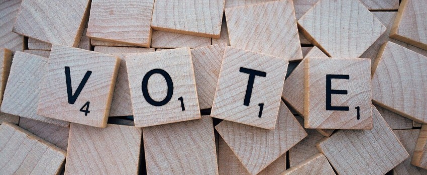 The word 'Vote' spelled out in scrabble letters