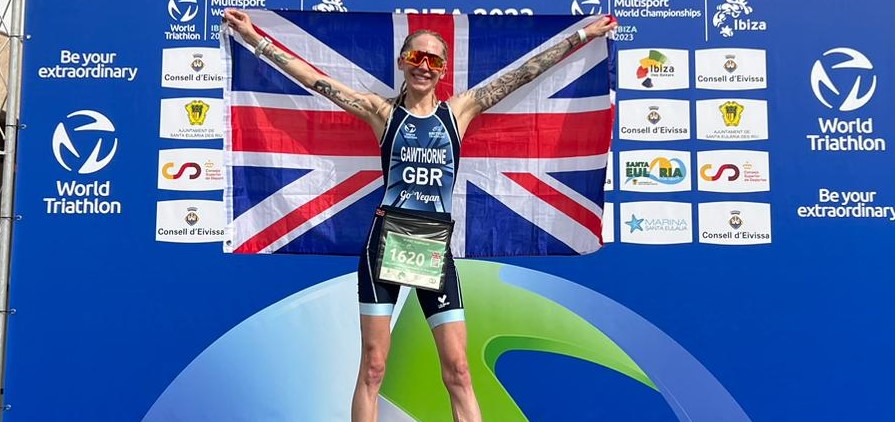 Vegan athlete, Lisa Gawthorne, in first place holding up UK flag