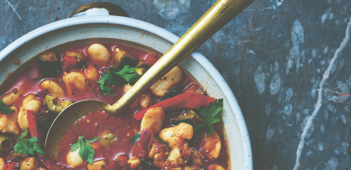 A bowl of aubergine, olive and butter bean stew.