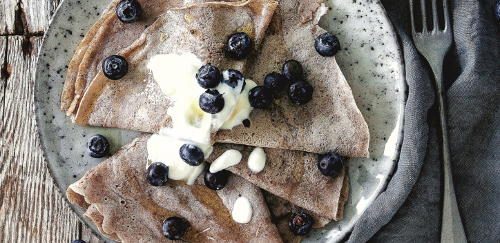 Buckwheat crepes presented on a plate with blueberries