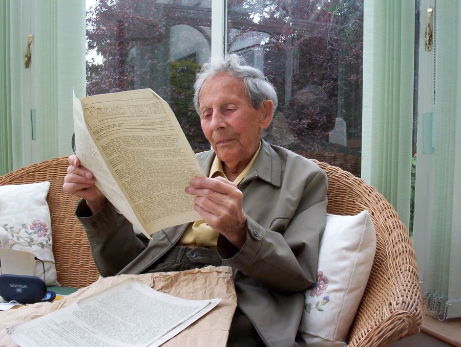 Donald Watson reading a copy of The Vegan