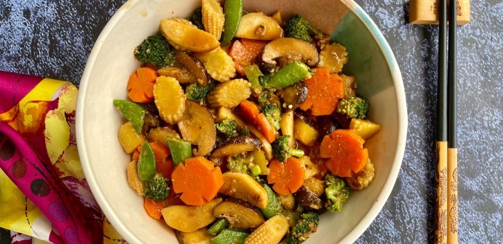 Braised mushrooms with vegetables served at a table