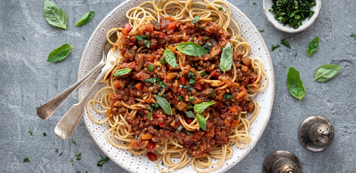 Lentil Bolognese served on a plate with fresh herbs
