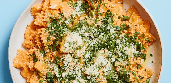 Red pepper pesto pasta served on a plate