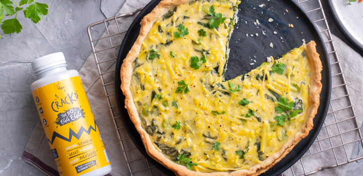 Crackd quiche in a pan next to bottle of Crackd The no-egg egg