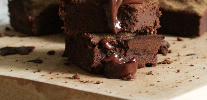 Stacked vegan brownies on a wooden chopping board.  Photo by Marta Dzedyshko from Pexels