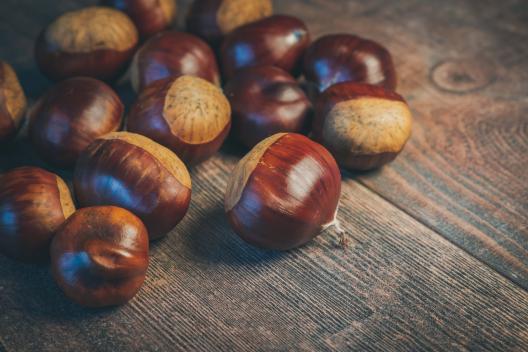 Chestnuts on a wooden table.  Photo by Ylanite Koppens from Pexels