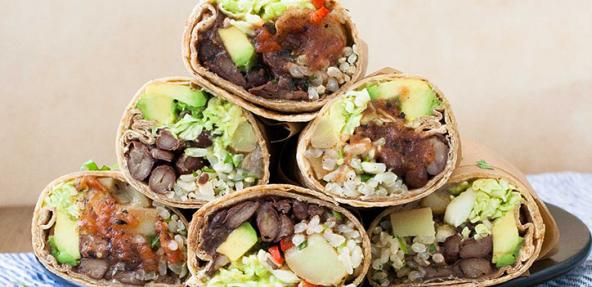 A stack of breakfast burritos on a plate