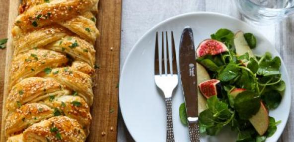 Paprika mustard leek and tofu plait next to a plate with salad.