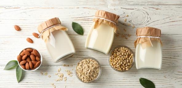 Variety of plant milks in a bottle next to ingredients