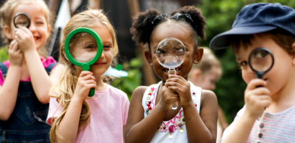 Children holding magnifying glasses