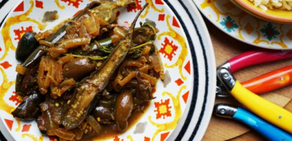 Aubergine, black olives and onion tagine stew served on a Morrocan styled plate.