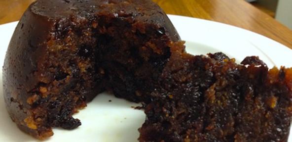 Vegan Christmas pudding served on a round plate.