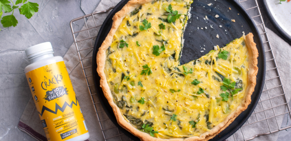 Crackd quiche in a pan next to bottle of Crackd The no-egg egg