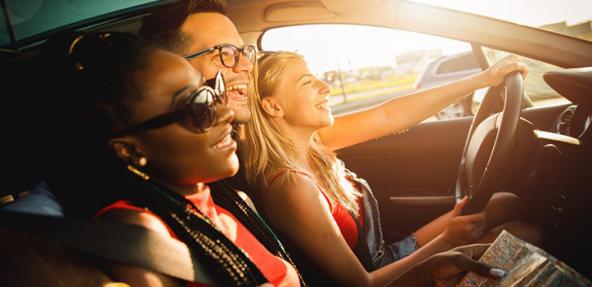 Three people smiling in a car