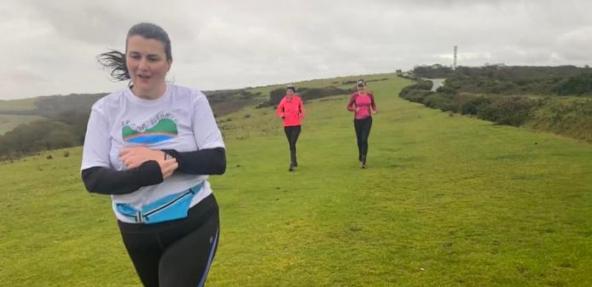 Amy running through field with friends