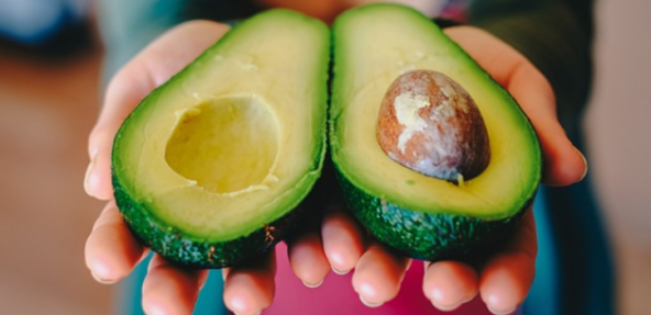 An avocado cut in half: a great inclusion into your balanced and varied diet