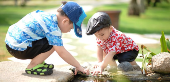 Two young children playing together. Childhood is a great time to introduce healthy eating patterns.