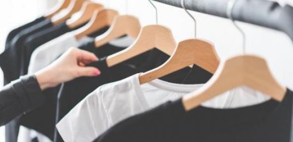 Black and white t shirts hanging on a clothes rail