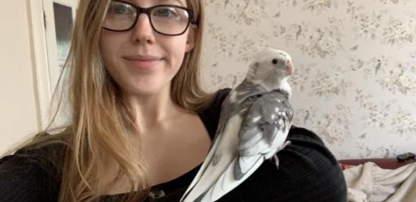 Vegan student Fiji with a bird on her shoulder