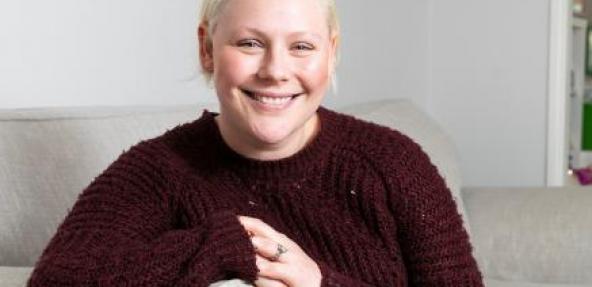 Picture of Laura Chepner sitting on sofa smiling