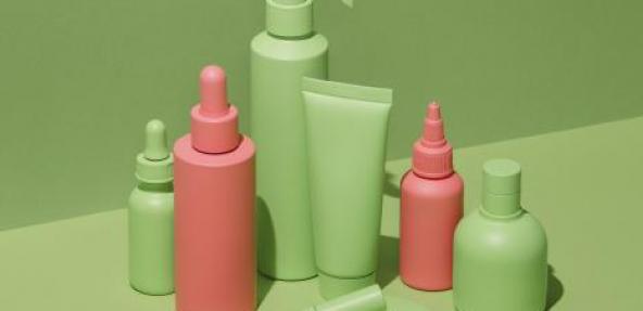 Green and orange cosmetic beauty products on green background