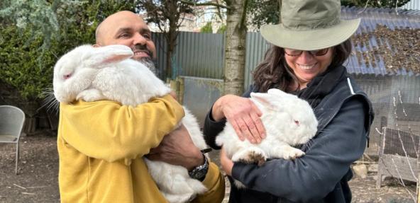 The Base Vegan Sanctuary staff holding white rabbits