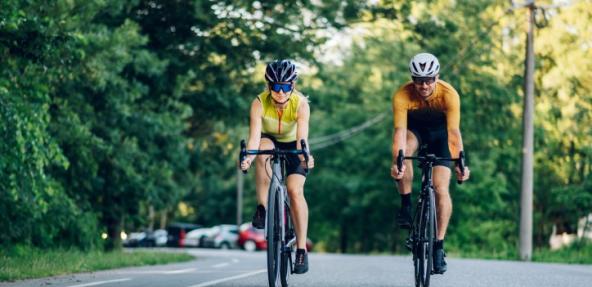 Two people cycling together