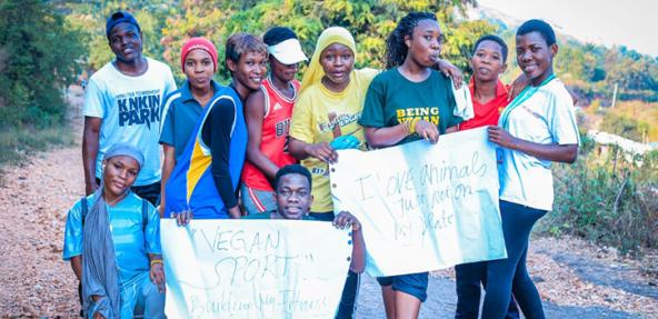 image of group from Bujumbura carrying out a vegan awareness campaign holding up signs