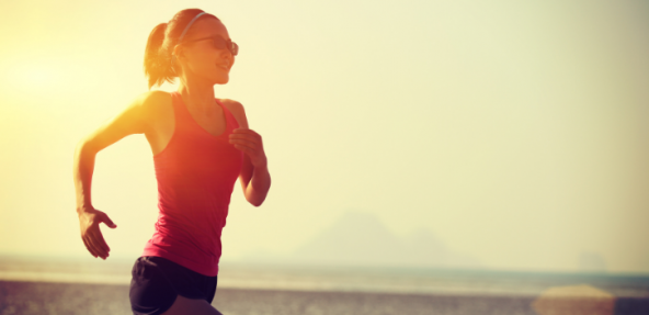 Woman in red top running in sunset