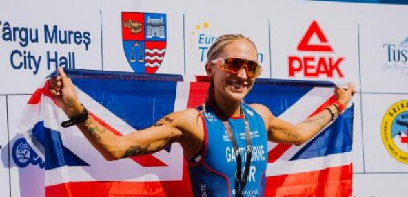 Vegan athlete Lisa Gawthorne holding up GB flag