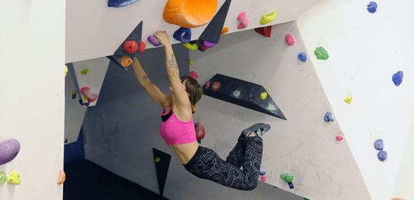 Two climbers doing indoor wall climbing