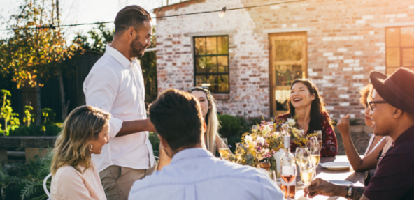 friends gathering for a summer outdoor dinner party