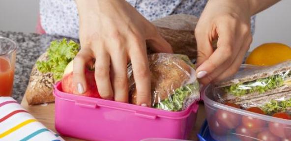 Person packing school lunches