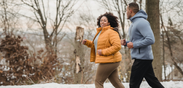 Two people running outside in the cold weather