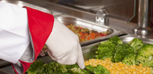 serving sweetcorn and broccoli in a canteen