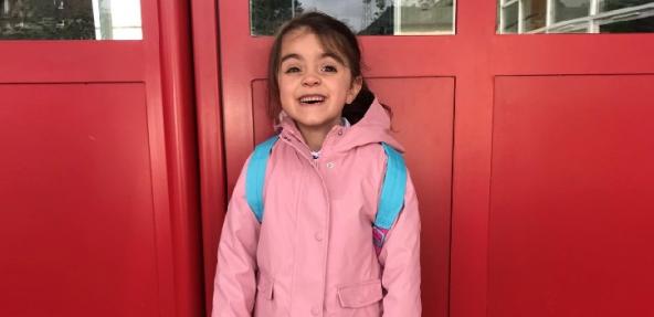 young girl outside her school