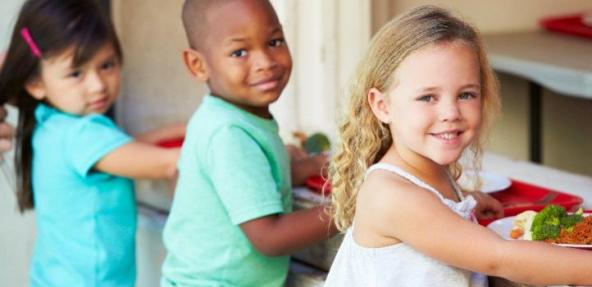 young children getting lunch