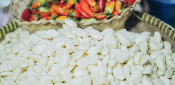 A close up of butter beans with a basket of mixed chillis in the background.  Photo by Elina Sazonova from Pexels