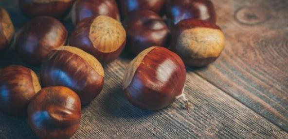 Chestnuts on a wooden table.  Photo by Ylanite Koppens from Pexels