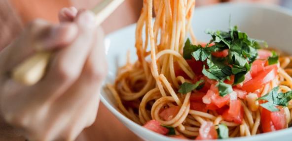 spaghetti in a bowl with tomatoes