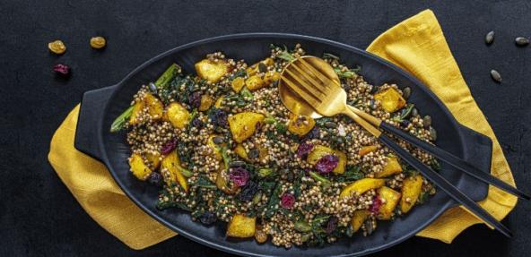 image of millet squash warm salad served in a bowl with knife and fork