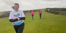 Amy running through field with friends