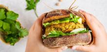 Person holding a vegan burger