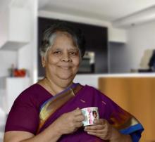Chef Akila holding a cup of tea