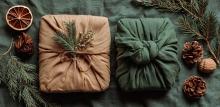 Presents wrapped surrounded by pine cones, dried leaves and dried oranges