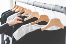 Black and white t shirts hanging on a clothes rail