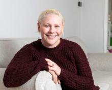 Picture of Laura Chepner sitting on sofa smiling