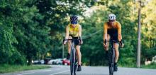 Two people cycling together