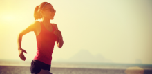 Woman in red top running in sunset